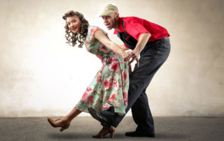 Couple dancing different types of swing dance styles