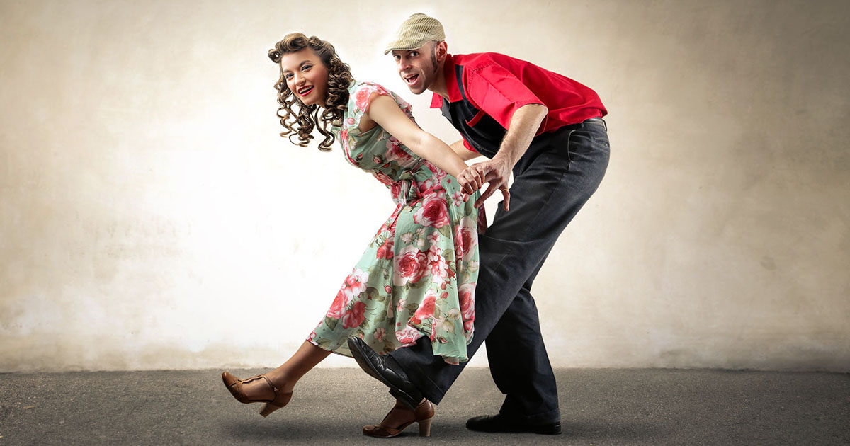 Couple dancing different types of swing dance styles